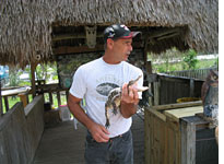 Roy Cotton tries to convince the ladies to hold an alligator