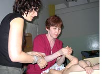 Baby massage, performed by a professional. Click image to expand.