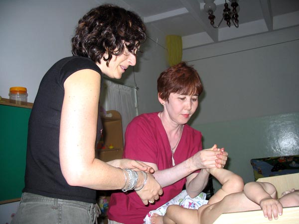 Baby massage, performed by a professional.