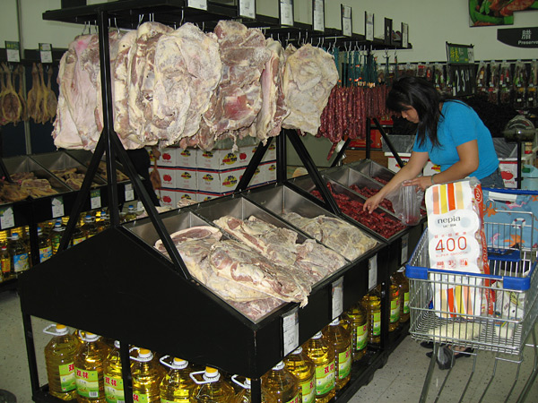 Hanging carcasses at the market.
