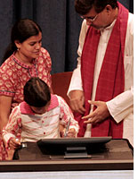 Devli Kumari signs her name at the "Education for All" pledge summit. Click image to expand.