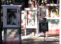 Many graves are draped in the Iranian flag