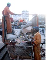 Garbage men load a truck near the Bab al-Yaman