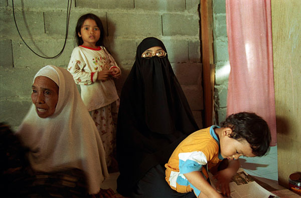 Paridah with son Khubaib, at right, and daughter Hannah, left; at the far left is the mother of Ali Gufron, alias Mukhlas, who is awaiting a death sentence for coordinating the 2002 terrorist attacks in Bali.