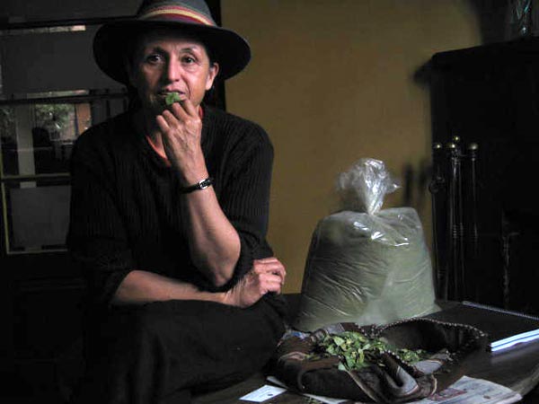 Silvia Rivera, Morales' coca adviser, chewing coca leaf and sitting next to a bag of coca flour.