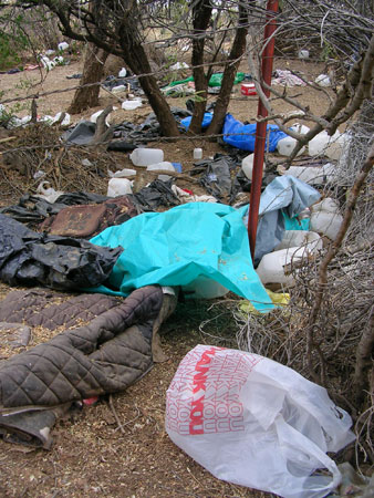 A lay-up for undocumented immigrants at Mile Marker 157 along Interstate 8 in Arizona. Immigrants wait here, sometimes for several days, waiting for rides to cities. Often, whatever they carry, other than one good set of "city clothes," is left behind.