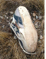 An immigrant’s shoe at the Mile Marker 157 lay-up. Click image to expand.