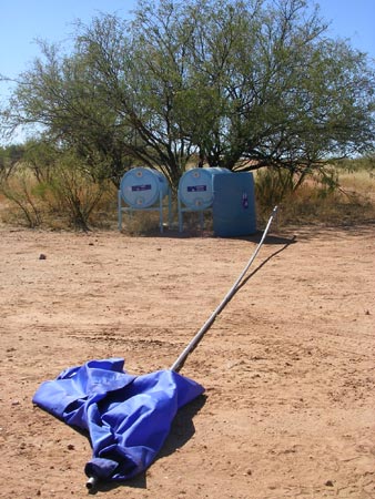 A flag indicating water tanks for border crossers set up by a humanitarian group near Sasabe, Ariz.