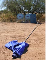 A flag indicating water tanks for border crossers set up by a humanitarian group. Click image to expand.