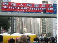 Matt Pearce, aka Spiderman, unfurls his pro-democracy banner. Click image to expand.