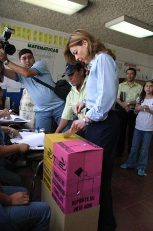 A woman votes in San Salvador Sunday.