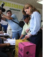 A woman votes in San Salvador Sunday. Click image to expand.