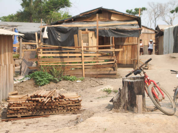 More than 400 families live in the 12-acre encampment; building materials come from the scrap piles of a nearby sawmill.