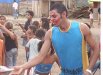 On Children's Day, each household in the encampment baked a small piece of what would be a giant cake; the main event was a clown with a face made up in lipstick. 
Click image to expand.