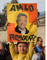 A supporter of López Obrador holds a sign declaring that he is president 
Click image to expand