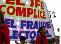 Students from a local university hold a sign that reads "IFE: Accomplice in Electoral Fraud"
Click image to expand