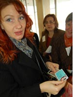 A power station employee shows off her electronic badge. Click image to expand