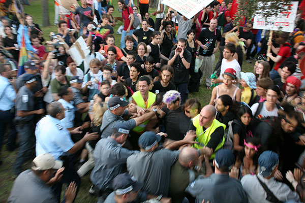 Police lunge at the anti-war protesters.