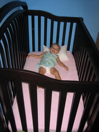 Our daughter tries out her new crib. We're still in the process of replacing all the furniture we lugged out of our moldy house in New Orleans.