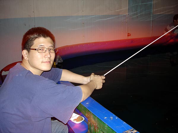 Lee trolls the waters of a basement fishing hall in Busan's Gwangan neighborhood.