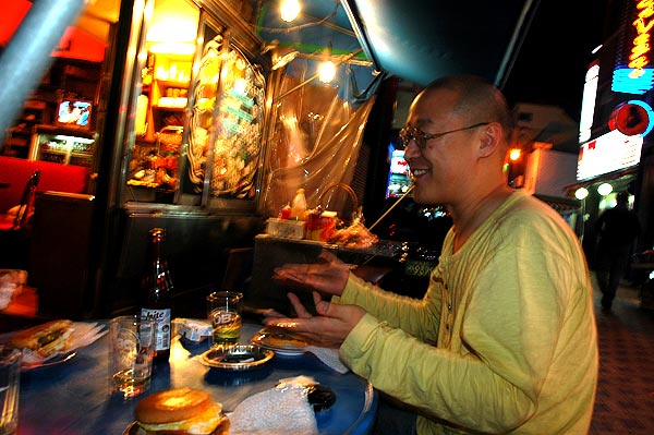 Filmmaker Wonsuk Chin enjoys a cheeseburger.