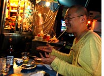 Filmmaker Wonsuk Chin enjoys a cheeseburger. Click image to expand.