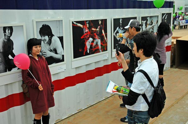 Tourists pose near a beach pavilion at PIFF. The popularity of "Korean Wave" filmmaking has a made the Busan event a big draw in Asia.