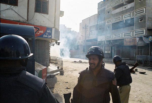 Police amid the billowing tear gas in Karachi, May 13.