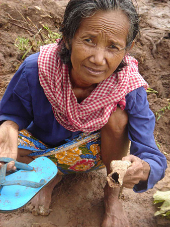 Chey Mao with a fragment of bone.