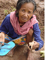 Chey Mao with a fragment of skull
Click image to expand.