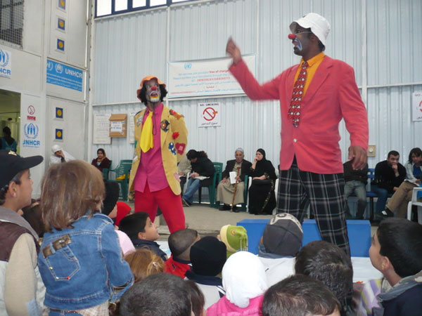 While Iraqis who fled the war in their country are waiting to register as refugees, Iraqi clowns stage a performance about the need for the children to attend school. UNHCR's research shows that 76 percent of Iraqi children are not enrolled in Syrian schools, although they are accessible and free.