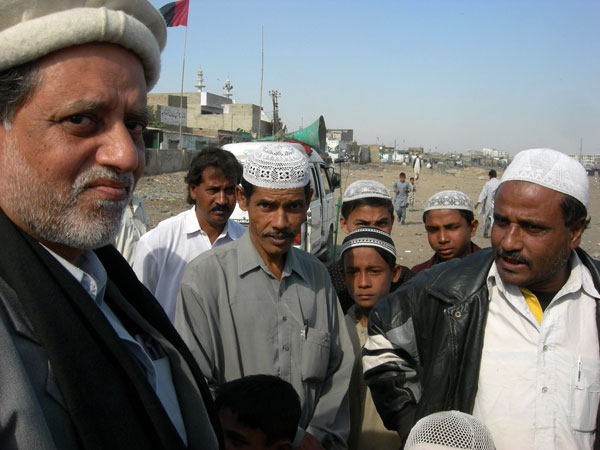 Syed Hafeezuddin (left) tries to win over voters.