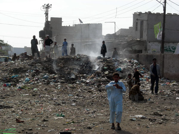 A trash fire in the Machar Colony slum.