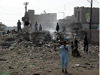 A trash fire in the Machar Colony slum
Click image to expand.