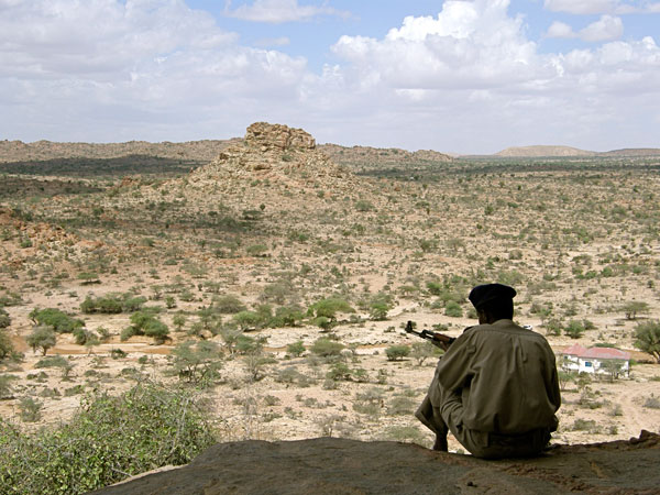 Somaliland soldier sitting outside an archaeological site that attracts foreign visitors. 