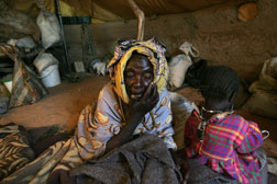An elderly Sudanese refugee sits in her tent in the Oure Cassoni Refugee Camp. Click image to expand.