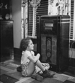 A girl listening to the radio during the Great Depression. Click image to expand.