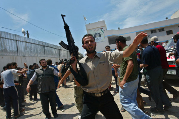 Palestinians gather at the site of an Israeli missile strike.