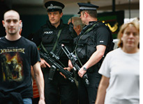 Armed police patrol Glasgow Airport. Click image to expand.