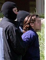 German security leads a suspected terrorist to court
Click image to expand.