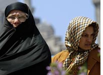 A Turkish woman in a chador beside a woman in a traditional headscarf. Click image to expand.