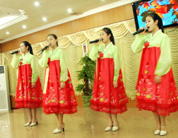 North Korean waitresses perform for patrons. Click image to expand.