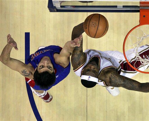 LeBron James (right) puts up a shot against the Pistons' Carlos Delfino.