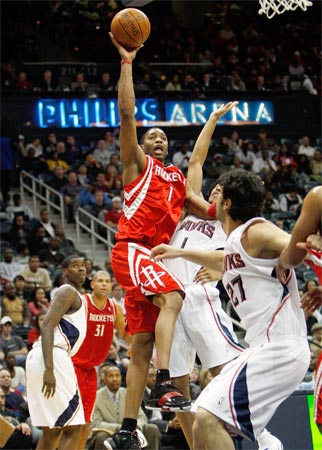 The Rockets' Tracy McGrady makes a shot over the Hawks' Josh Childress.