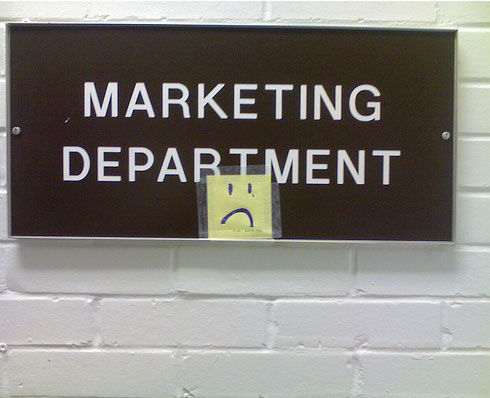 A sign in the Virginian-Pilot building on Dec. 2 in Norfolk, Va. About a week earlier, the newspaper announced a 10 percent reduction in its work force, including the marketing department.