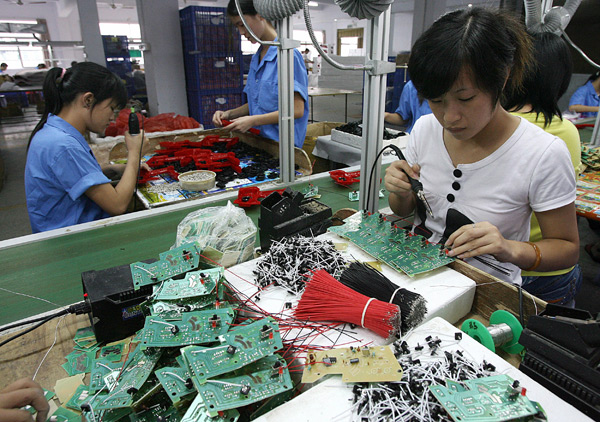 Workers assembling toys on a production line in Shantou, China.