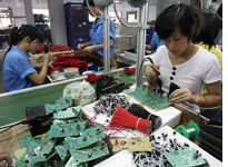 Workers assembling toys on a production line in Shantou, China. Click image to expand.