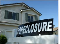 A foreclosure sign sits in front of a home