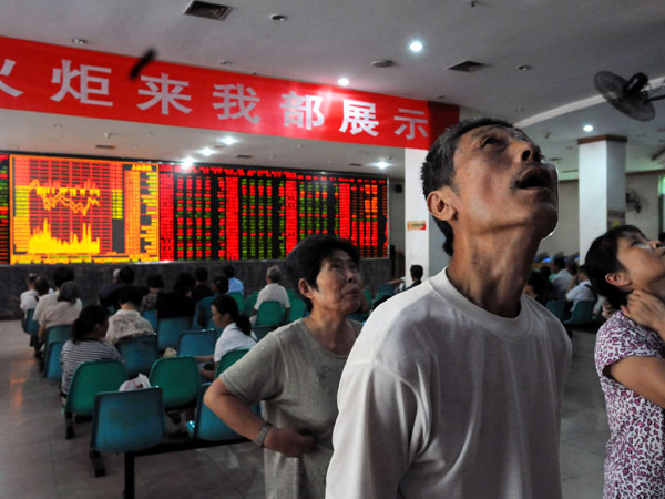 Investors view stock indexes in China.