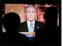 People watch Bush's Iraq speech. Click image to expand.